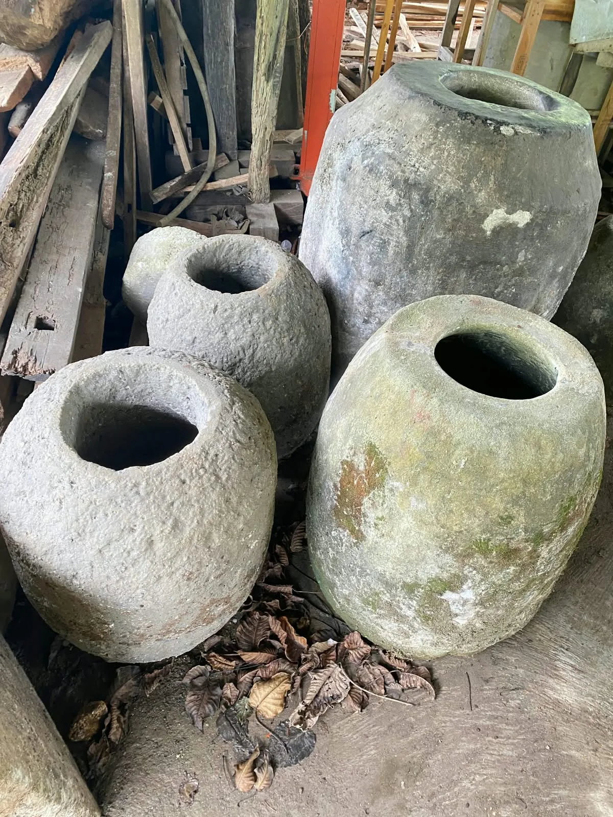 A group of aged-looking vessels photographed at a partner location
