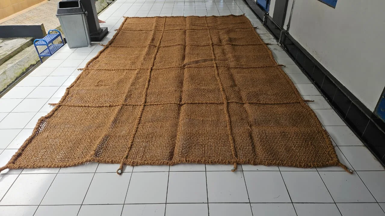Woven panels laid out on a workshop floor