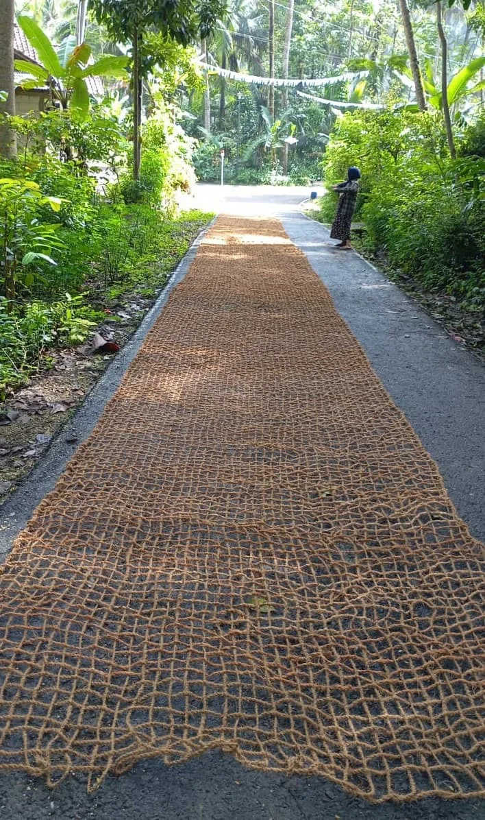 A long woven natural-fibre runner laid out at a partner workshop